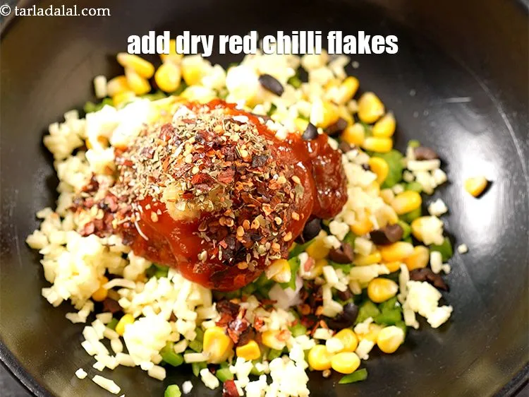Step 13 – Add 1/2 tsp <a href="https://www.tarladalal.com/glossary-dry-red-chilli-flakes-paprika-338i">dry red chilli flakes (paprika)</a>.
