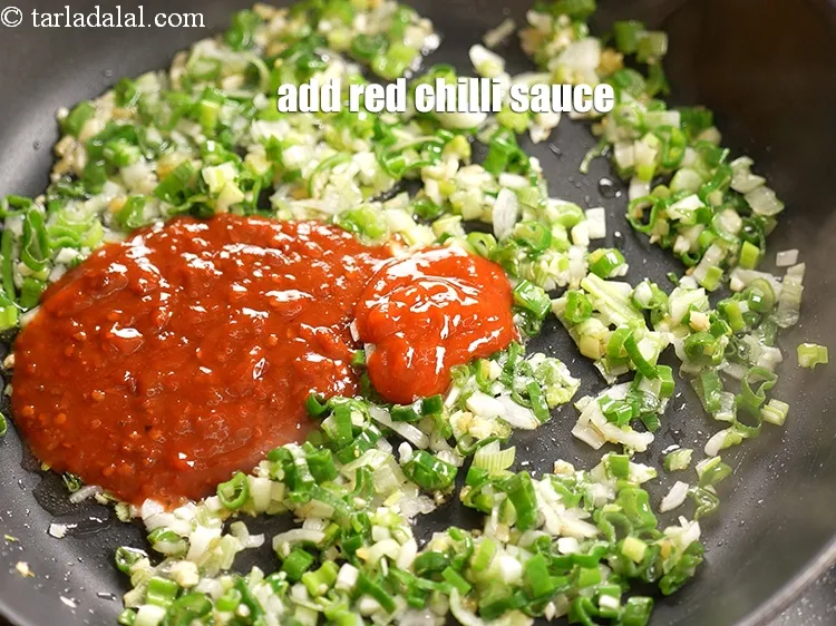 Step 13 – Add 1 tbsp <a href="https://www.tarladalal.com/glossary-red-chilli-sauce-lal-chilli-sauce-810i">red chilli sauce</a>.