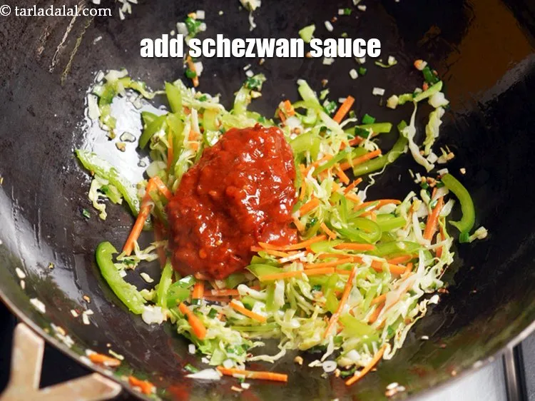 Step 13 – Add &frac14; cup <a href="https://www.tarladalal.com/glossary-schezwan-sauce-schezuan-sauce-1872i">schezwan sauce</a>.