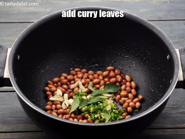 Step 12 – Add <a href="https://www.tarladalal.com/glossary-curry-leaves-kadi-patta-kadipatta-388i" target="_blank">curry leaves</a>.