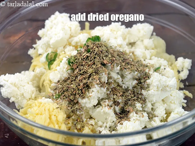 Step 13 – Add 2 tsp <a href="https://www.tarladalal.com/glossary-dried-oregano-268i">dried oregano</a>.