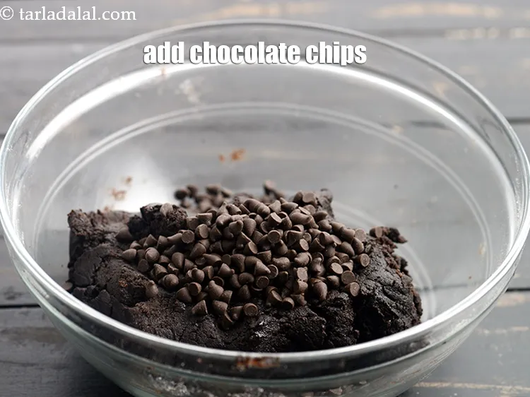 Step 13 – Add &frac14; cup <a href="https://www.tarladalal.com/glossary-chocolate-chips-325i">chocolate chips</a>.