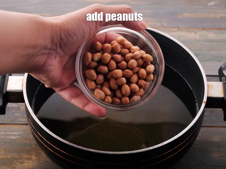 Step 15 – In the same hot <a href="https://www.tarladalal.com/glossary-oil-671i" target="_blank">oil</a>, add the peanuts.