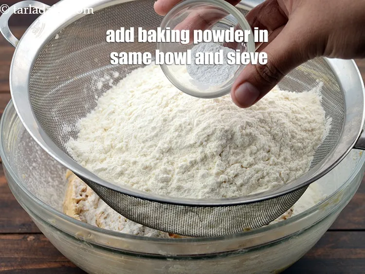 Step 13 – Add 1/2 tsp&nbsp;<a href="https://www.tarladalal.com/glossary-baking-powder-425i">baking powder</a> in the same bowl and sieve well.