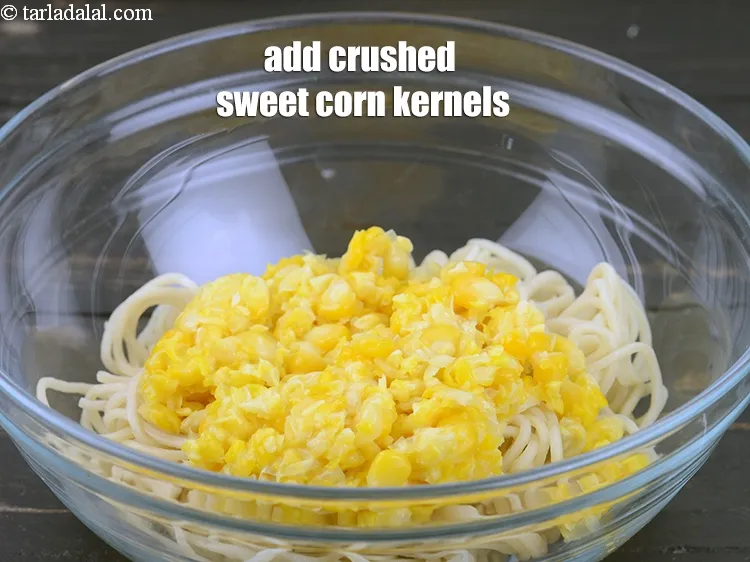 Step 14 – Add 1/2 cup&nbsp;<a href="https://www.tarladalal.com/glossary-sweet-corn-kernels-makai-ke-dane-156i">sweet corn kernels (makai ke dane)</a>, boiled and coarsely crushed.