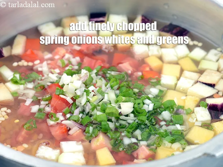 Step 14 – Add &frac14; cup finely <a href="https://www.tarladalal.com/glossary-chopped-spring-onion-whites-815i">chopped spring onions whites</a>&nbsp;and greens.