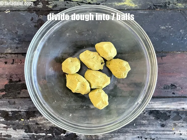 Step 13 – <meta charset="UTF-8" />To make the&nbsp;<strong>handmade</strong>&nbsp;<strong>bajra khakhra</strong>, divide the dough into 7&nbsp;equal portions.&nbsp;