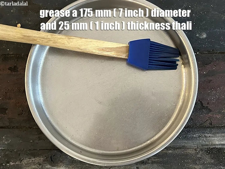 Step 18 – <meta charset="UTF-8" /> Grease a&nbsp;175mm. (7&rdquo;) diameter and 25mm. (1&rdquo;) thickness thali.