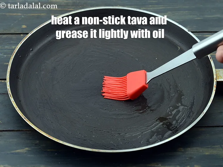 Step 13 – Heat a non-stick tava (griddle) and grease it lightly using oil.