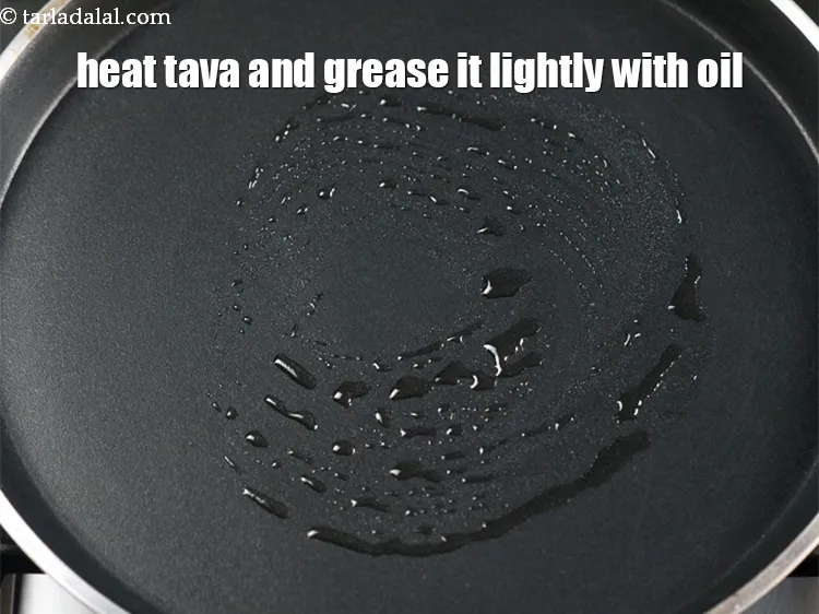 Step 13 – Heat a non-stick tava (griddle) and grease it lightly with &frac12; tsp of oil.