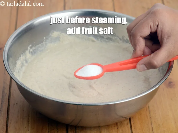 Step 13 – Just before steaming, add 1 tsp <a href="https://www.tarladalal.com/glossary-fruit-salt-420i">fruit salt</a>.