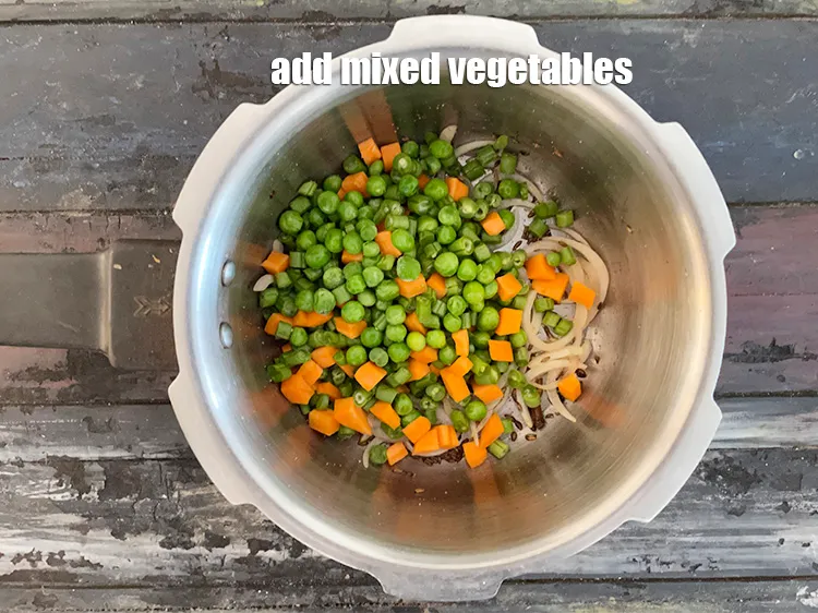 Step 29 – Add&nbsp;<meta charset="UTF-8" />1 cup&nbsp;<a href="glossary-mixed-vegetables-mixed-sabzi-723i">mixed vegetables</a>&nbsp;(french beans , carrot and green peas).