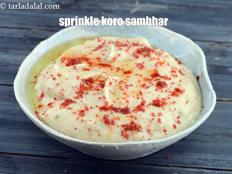 Step 13 – And sprinkle <a href="https://www.tarladalal.com/glossary-koro-sambhar-2567i">koro sambhar</a>.