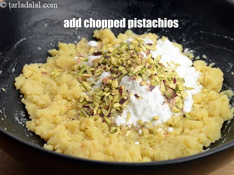 Step 13 – Add 1 &frac12; tbsp <a href="https://www.tarladalal.com/glossary-blanched-and-chopped-pistachios-2078i">chopped pistachios</a>.