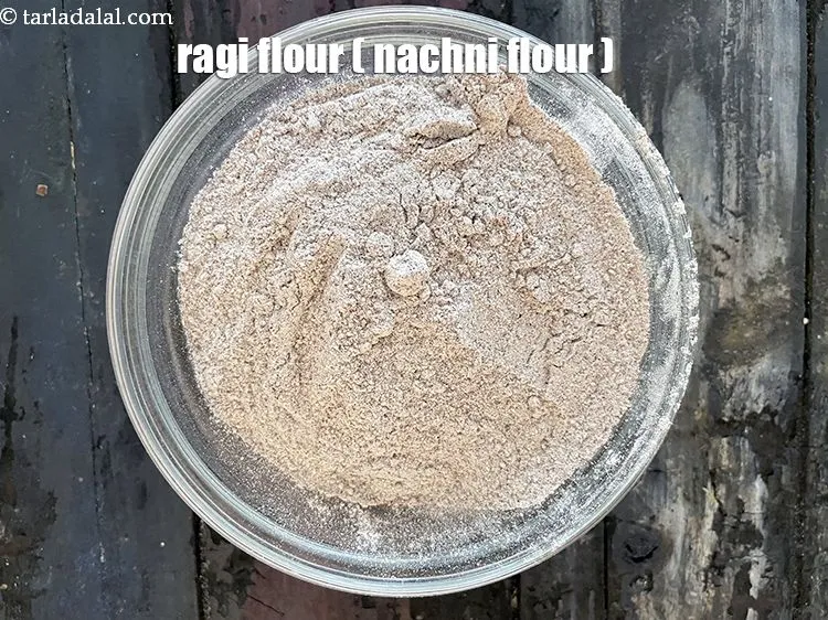 Step 5 – In a bowl put&nbsp;<meta charset="UTF-8" />1 cup&nbsp;<a href="glossary-ragi-flour-nachni-flour-nachni-ka-atta-red-millet-flour-1115i">ragi (nachni / red millet) flour</a>.