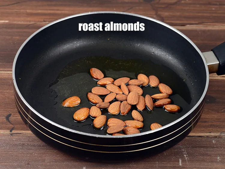 Step 13 – Roast &frac14; cup <a href="https://www.tarladalal.com/glossary-almonds-badam-378i">almonds (badam)</a>.