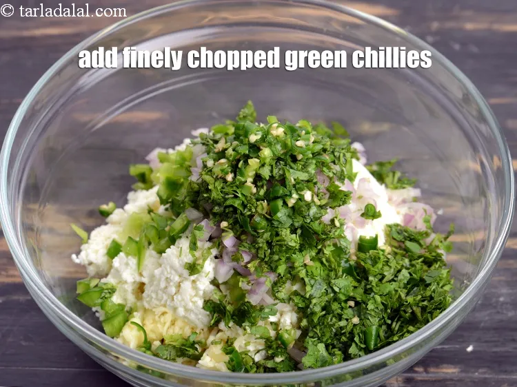 Step 14 – Add 1 1/2 tsp finely <a href="https://www.tarladalal.com/glossary-chopped-green-chilli-820i">chopped green chillies</a>.