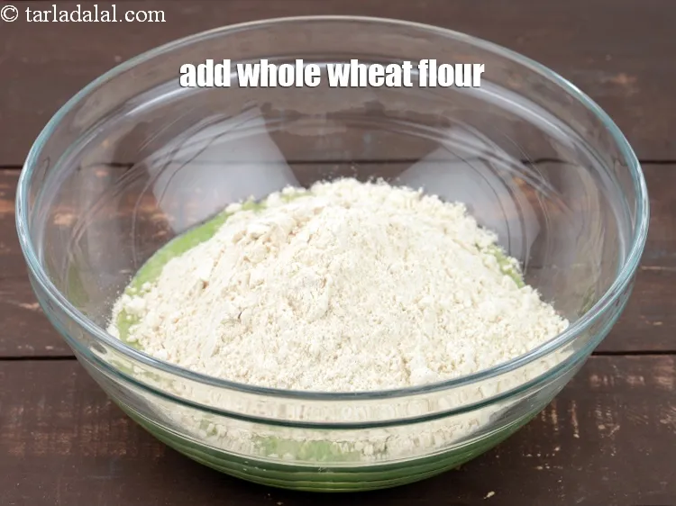 Step 13 – Add 1 cup <a href="https://www.tarladalal.com/glossary-whole-wheat-flour-gehun-ka-atta-gehun-ka-aata-429i">whole wheat flour (gehun ka atta)</a>.