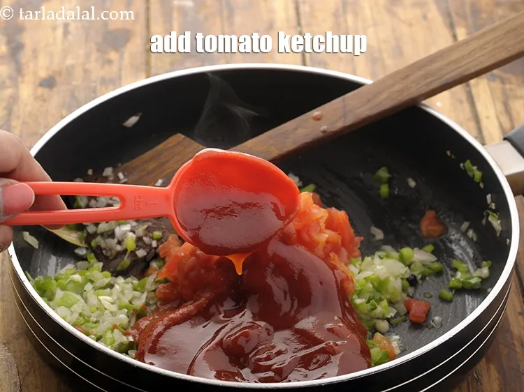 Step 12 – Add tomato ketchup. It provides pizza sauce a beautiful color and tangy flavor.