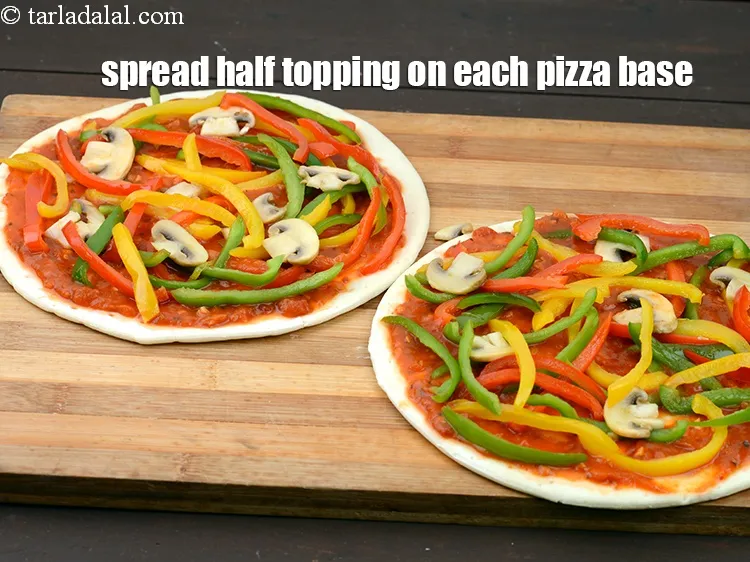 Step 21 – Spread half the topping evenly on each pizza base.