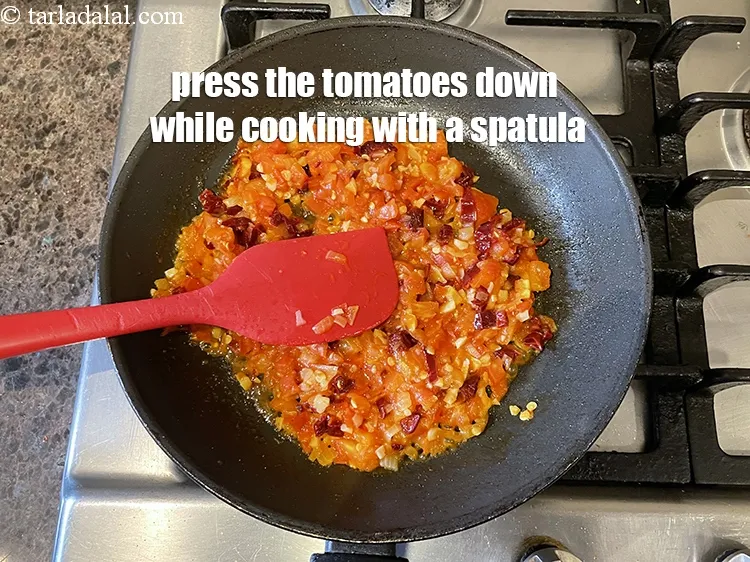 Step 26 – Press the tomatoes down with a spatuala while cooking.
