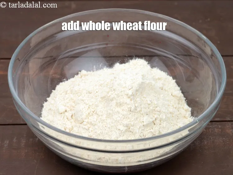 Step 12 – Add 1 1/2 cup <a href="https://www.tarladalal.com/glossary-whole-wheat-flour-gehun-ka-atta-gehun-ka-aata-429i">whole wheat flour (gehun ka atta)</a>.