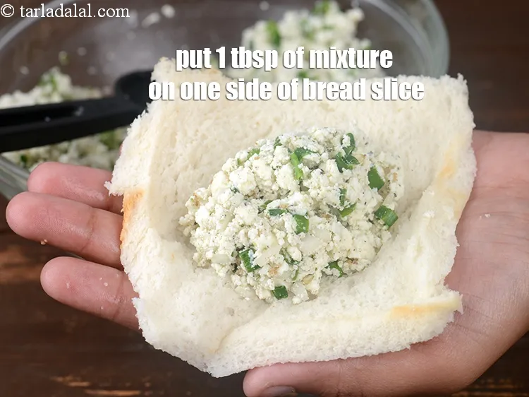 Step 13 – Put 1 tbsp of the mixture on one side of the bread slice.