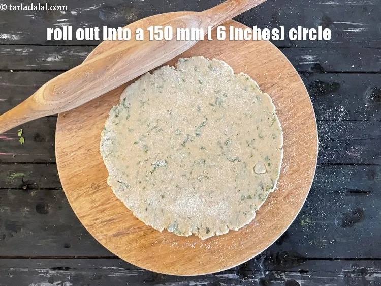 Step 13 – Roll out a portion into a circle of 150 mm (6&rdquo;) diameter, using a little …