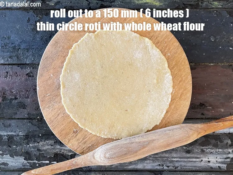 Step 14 – <meta charset="UTF-8" />Using a little whole wheat flour for rolling, start rolling out the dough …