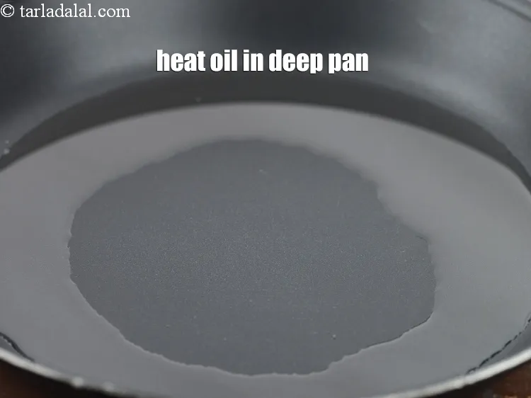 Step 13 – Heat 2 tbsp <a href="https://www.tarladalal.com/glossary-oil-671i">oil</a> in deep non-stick pan.