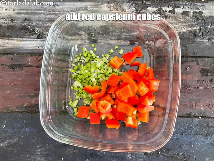Step 19 – Add&nbsp;<meta charset="UTF-8" />1/2 cup&nbsp;<a href="glossary-red-capsicum-cubes-2077i">red capscium cubes</a>.&nbsp;Rich in&nbsp;<a href="https://www.tarladalal.com/recipes-for-Vitamin-C-Rich-Indian-Recipes-804">vitamin C</a>,&nbsp;<a href="https://www.tarladalal.com/recipes-using-capsicum-163">capsicum</a>&nbsp;protect and maintain the lining …