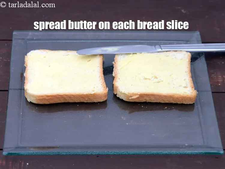 Step 13 – Spread &frac12; tsp of <a href="https://tarladalal.com/glossary-butter-makhan-233i">butter</a>&nbsp;on each bread slice.