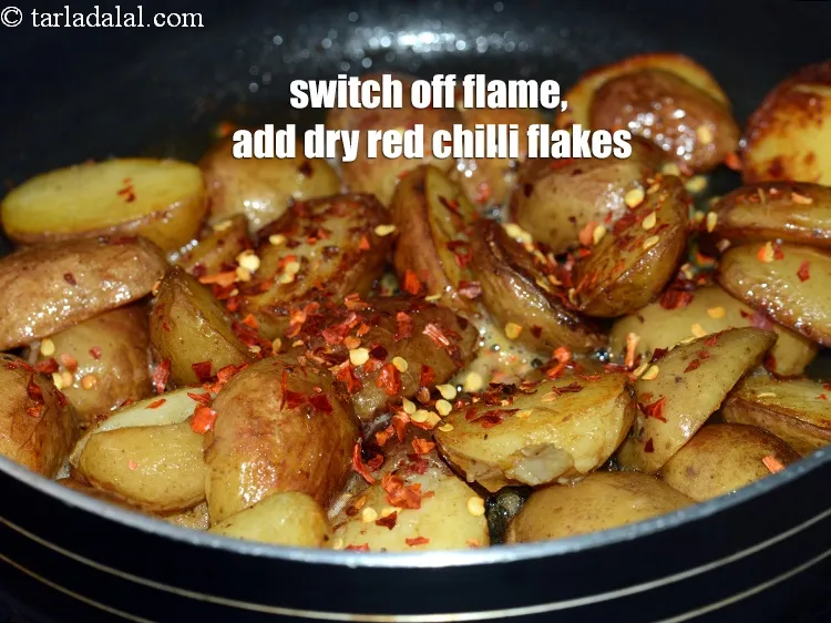 Step 14 – Switch off the flame, add 1 tsp <a href="https://www.tarladalal.com/glossary-dry-red-chilli-flakes-paprika-338i">dry red chilli flakes (paprika)</a>.