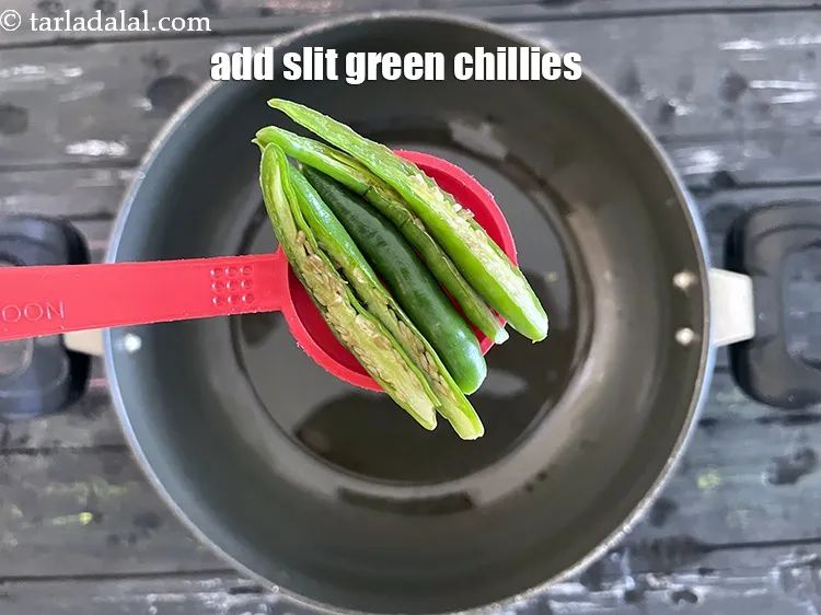 Step 13 – Add <strong>3&nbsp;tsp&nbsp;green chillies, slit each into 2.</strong>