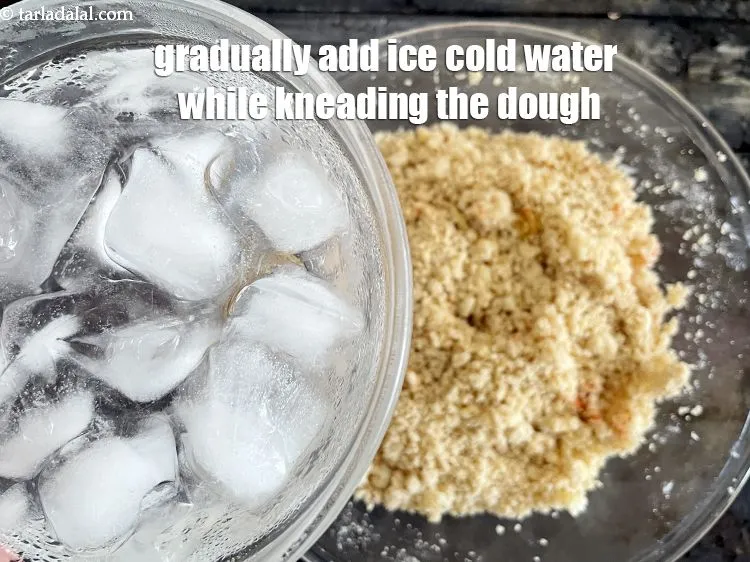 Step 17 – Gradually add 3&nbsp;tbsp of ice-cold water while kneading the dough.