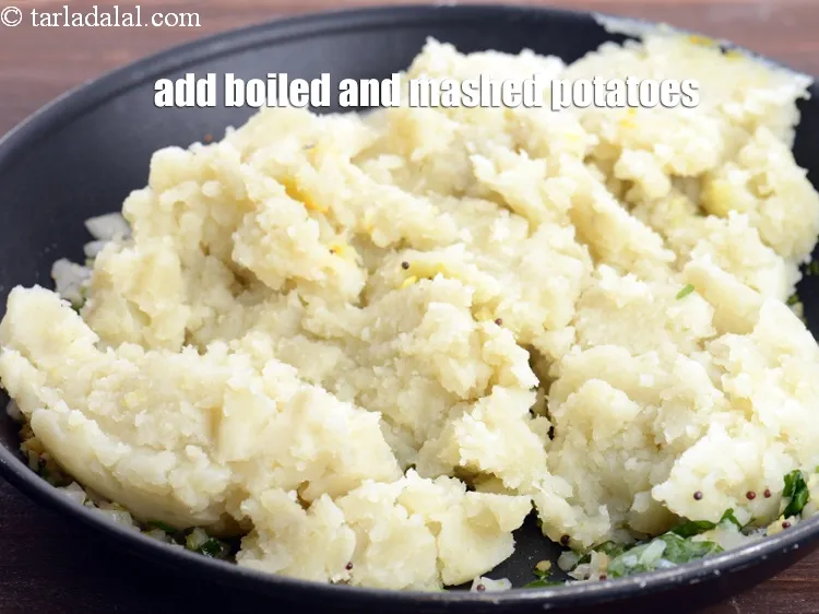 Step 15 – Add 1&frac14; cups boiled and <a href="https://www.tarladalal.com/glossary-boiled-and-mashed-potatoes-1831i">mashed potatoes</a>.