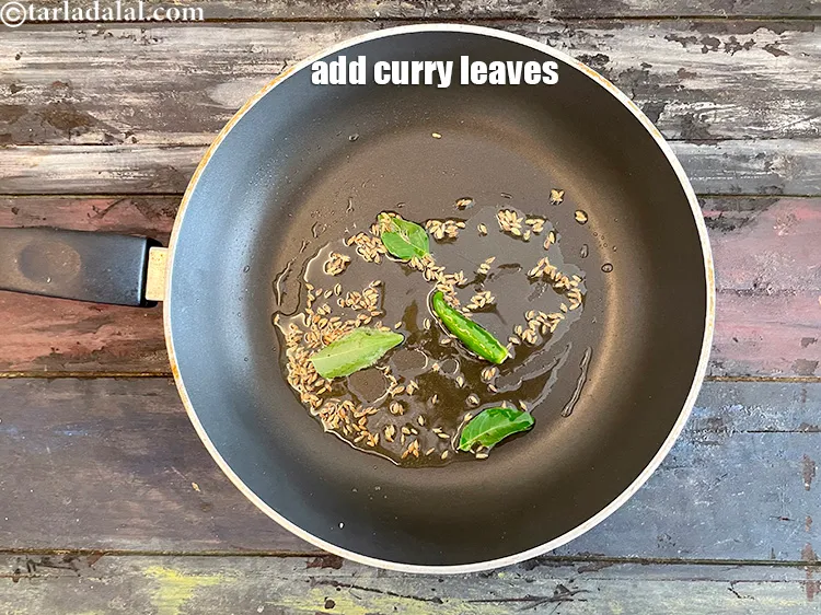 Step 14 – <html><head></head><body><p>Add&nbsp;3 to 4&nbsp; <a href="glossary-curry-leaves-kadi-patta-kadipatta-388i">curry leaves (kadi patta)</a>.</p></body></html>
