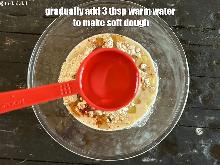 Step 14 – Gradually add<strong> 3&nbsp;tbsp warm water t</strong>o make soft dough.