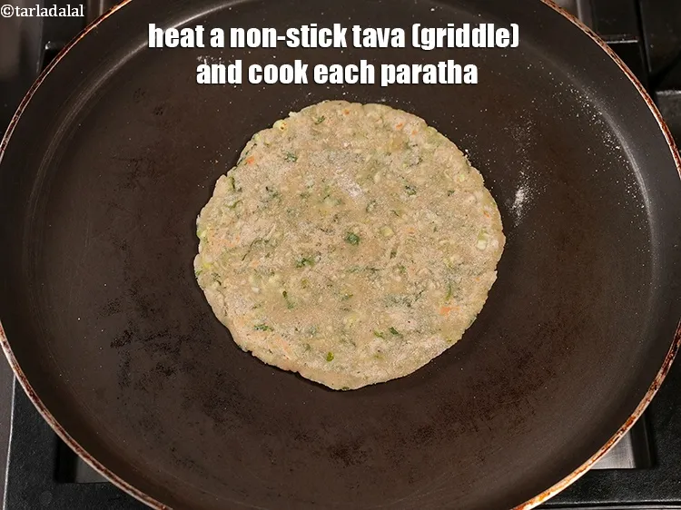 Step 15 – Heat a non-stick tava (griddle) and cook each paratha.