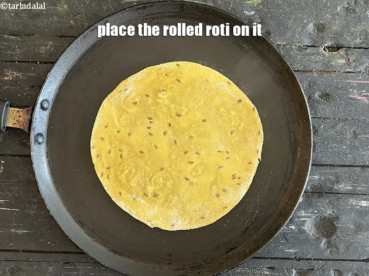 Step 14 – Place the rolled roti on it.