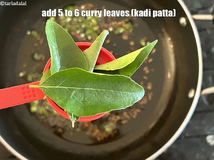 Step 14 – Add&nbsp;<meta charset="UTF-8" />5 to 6&nbsp;<a href="glossary-curry-leaves-kadi-patta-kadipatta-388i">curry leaves (kadi patta)</a>.