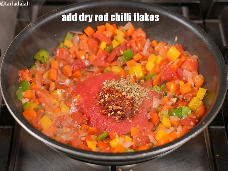 Step 14 – Add 1 tsp <a href="https://www.tarladalal.com/glossary-dry-red-chilli-flakes-paprika-338i">dry red chilli flakes (paprika)</a>.