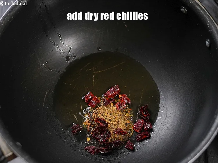 Step 14 – Add 2 tsp dry <a href="https://www.tarladalal.com/glossary-pandi-chillies-pandi-dry-red-chillies-2373i">pandi chillies</a>.