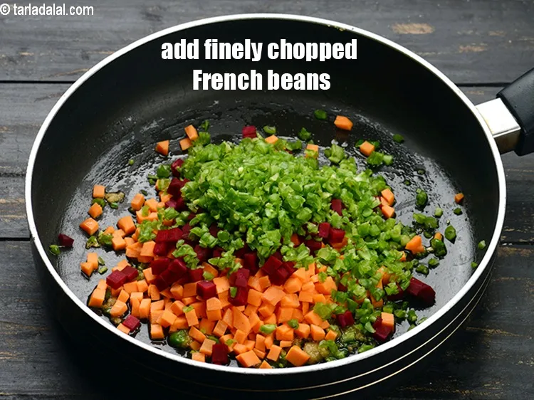 Step 15 – Add 1/3 cup finely <a href="https://www.tarladalal.com/glossary-chopped-french-beans-797i">chopped french beans</a>.