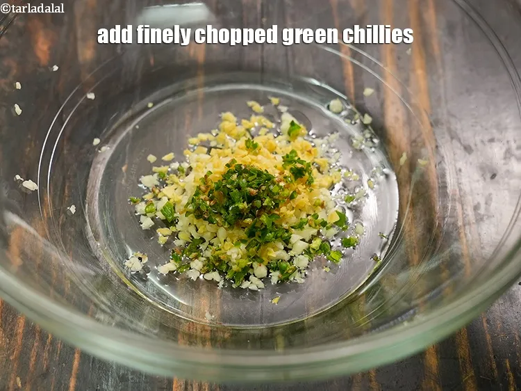 Step 14 – Add 1 tsp finely <a href="https://www.tarladalal.com/glossary-chopped-green-chilli-820i">chopped green chillies</a>.