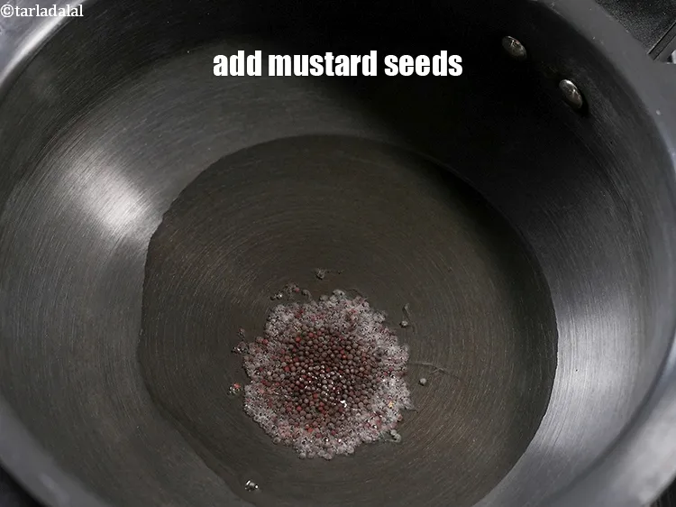 Step 14 – Add 1 tsp <a href="https://www.tarladalal.com/glossary-mustard-seeds-sarson-rai-sarson-ke-beej-525i">mustard seeds ( rai / sarson)</a>.