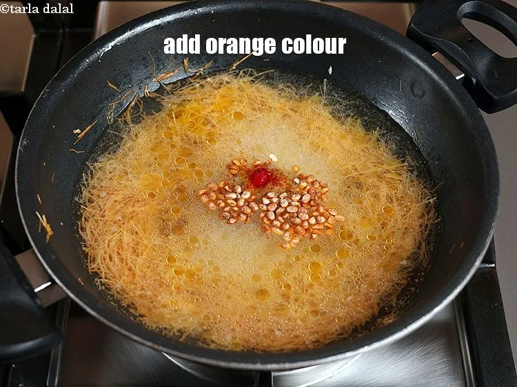 Step 14 – Add 1/8 tsp <a href="https://www.tarladalal.com/glossary-orange-colour-363i">orange colour</a>. Instead you can use saffron strands.