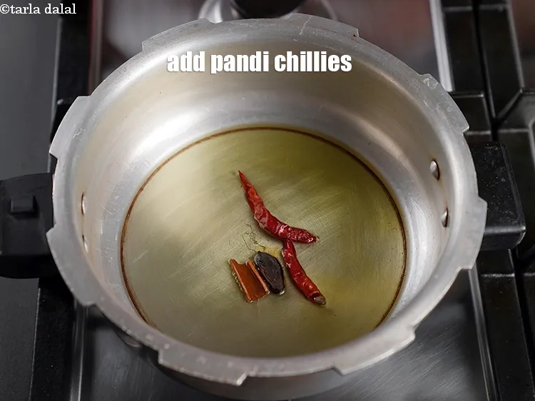 Step 14 – Add 2 dry pandi chillies.