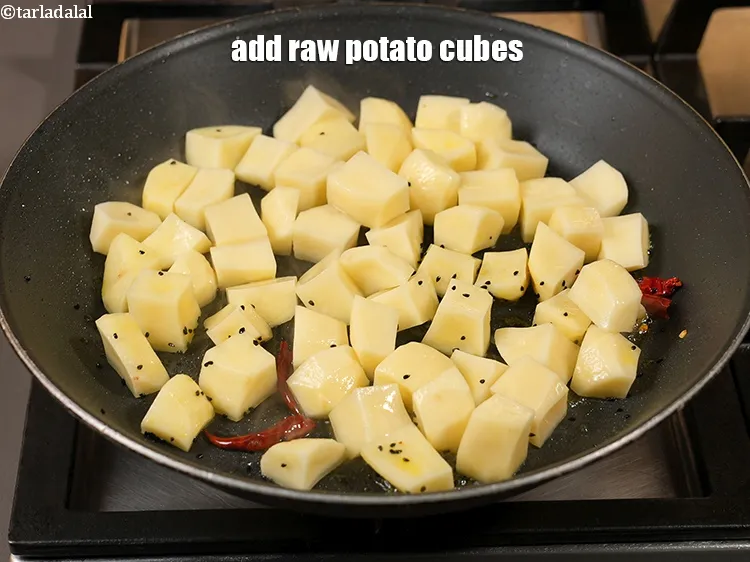 Step 14 – Add 3 cups raw <a href="https://www.tarladalal.com/glossary-potato-cubes-725i">potato cubes</a>.