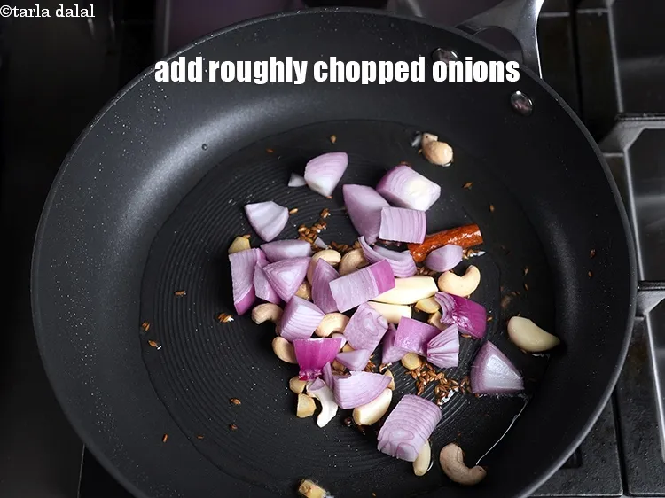 Step 14 – Add 1 cup roughly <a href="https://www.tarladalal.com/glossary-chopped-onions-722i">chopped onions</a>.
